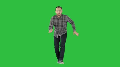 Young crazy man dancing and wanking forward on a Green Screen, Chroma Key.