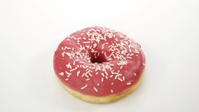 spinning donut with pink icing on a white background