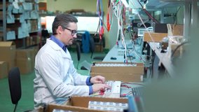 Young energetic male tech or engineer repairs electronic equipment in research facility. Shallow DOF, focus on the face of the worker. - Powered by Shutterstock - Get 15% off with code: PIKWIZARD15