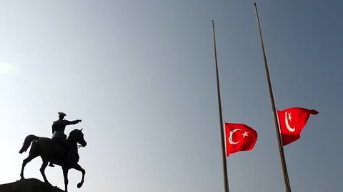 Mustafa Kemal Ataturk riding horse sculpture silhouette and Turkish flag, lower the flag to half-staff in 10 november
