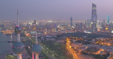 Drone aerial above Kuwait City panning around the iconic Kuwait Tower at night city light, 4K Aerial View of a landmark of Kuwait City, Kuwait