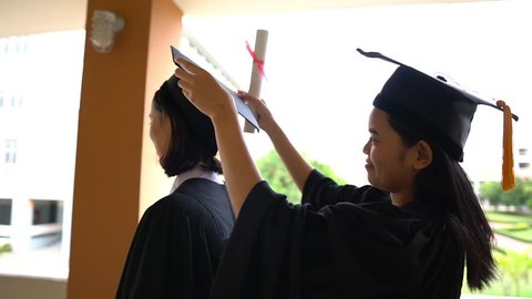 Black graduates wear black suits on graduation day at university.