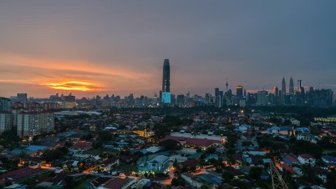 Time lapse of Kuala Lumpur city view during dawn overlooking the city skyline, 4k on motion slide down