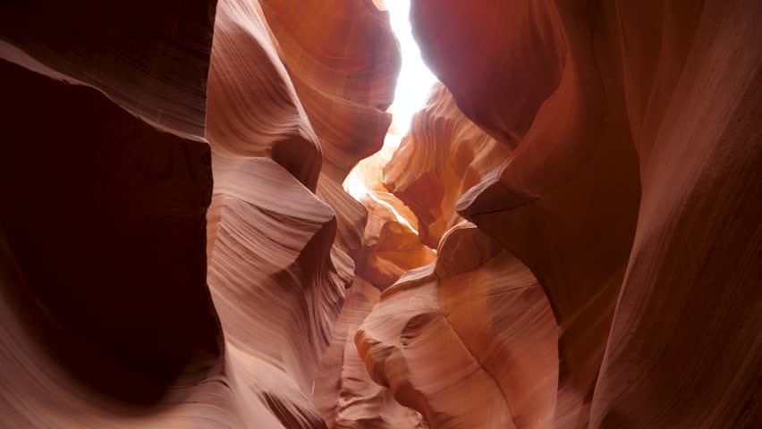 Movement on the antelope canyon with wavy and smooth sandstone walls of red color, amazing rock formations, beautiful place