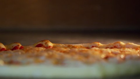 Italian Pizzaiolo Pizza Maker Prepares Pizza In The Kitchen Of The Restaurant.