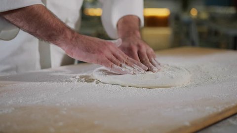 Italian Pizzaiolo Pizza Maker Prepares Pizza In The Kitchen Of The Restaurant.
