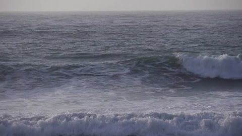 blue waves rushing toward beach slow motion