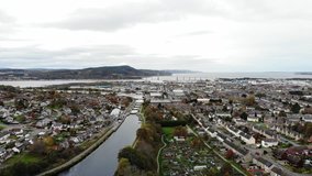 Aerial flyover shot of Caledonian Canal in Inverness, Scotland, UK
