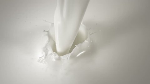 Close-up pouring milk in Slow Motion with crown splash. Shot with high speed camera.