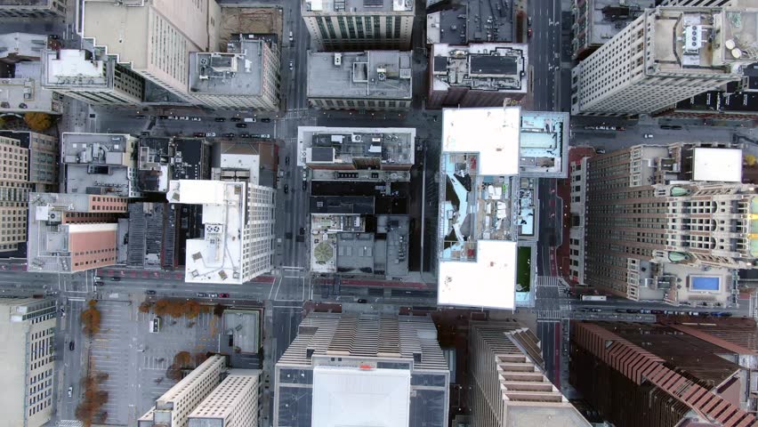 Top-down aerial view looks across downtown Baltimore streets, office rooftops, parking structures, and tightly packed blocks, 2018.