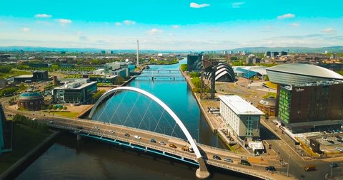 Drone shot pulling back from the Glasgow Arc (Squinty Bridge) revealing the River Clyde & the cityscape of Glasgow.