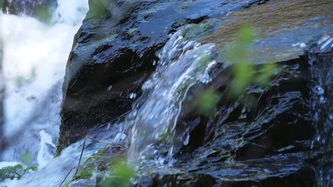 Crystal water waterfall cascade in forest slow motion