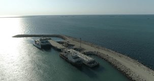 4K Aerial video filming of a container ships fixed in the port of Bautino on the shores of the Caspian Sea, Kazakhstan