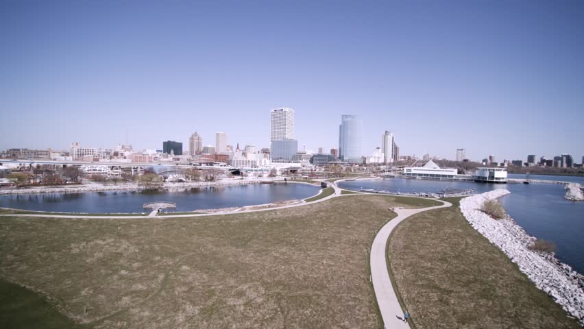 South West Aerial side motion view of Daytime Milwaukee City Skyline and Skyscrapers.