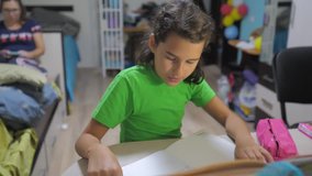 little girl daughter do homework education lesson school. slow motion video. preparation, back lifestyle to school. little girl study with a book. school kids family concept education