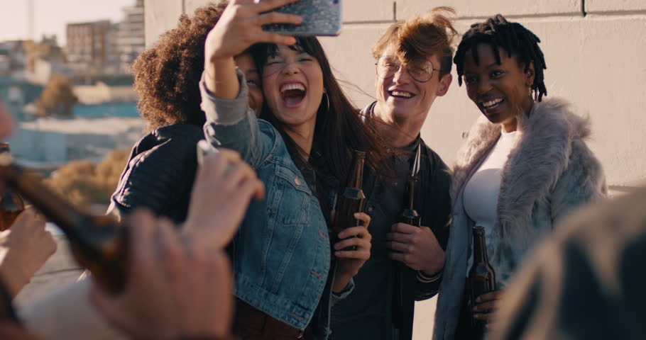 Slow motion happy rooftop party friends having fun young asian woman taking group photos using smartphone sharing weekend lifestyle on social media at sunset | Shutterstock HD Video #1020198631
