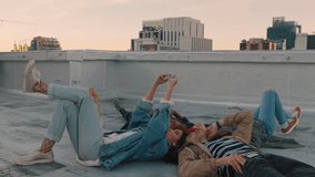 happy friends hanging out lying on rooftop taking selfie photo using smartphone camera enjoying sharing weekend together - Powered by Shutterstock - Get 15% off with code: PIKWIZARD15