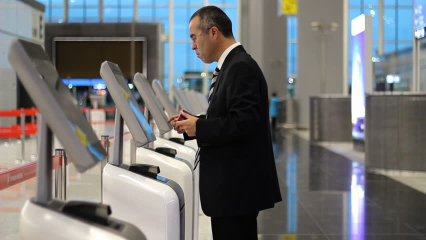 Passenger business man at the airport check in ticket at kiosk terminal
 Royalty-Free Stock Footage #1020223702