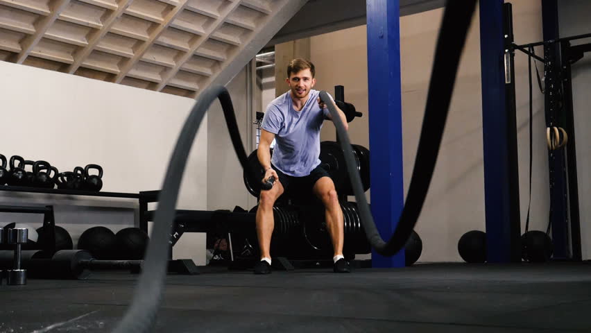 Man Workout in Gym. Using Battle Ropes. Gym Workout. Slow Motion Royalty-Free Stock Footage #1020229273