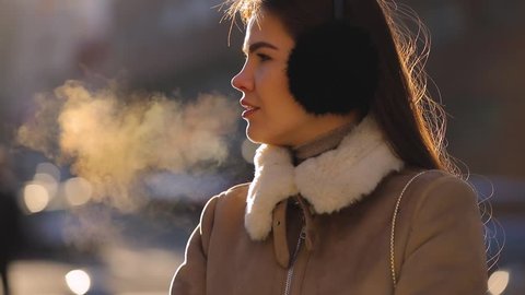 Outdoor woman portrait in cold winter city