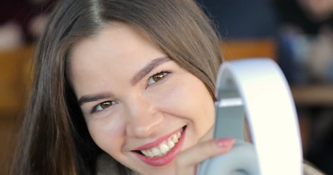 Portrait of cute cheerful young woman smiling wearing headphones