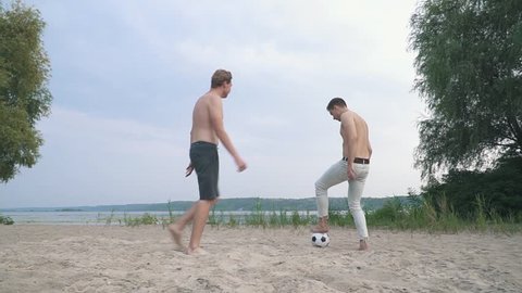 Two teenagers playing football Competition between people Friends have a fun together Spending time outdoors Active lifestyle