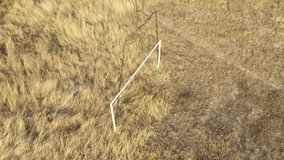 Construction of soccer goal in the field aerial 4K video