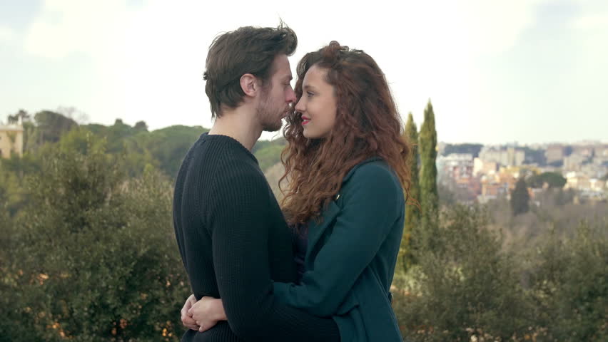 young man is flirting with a girl and kisses her