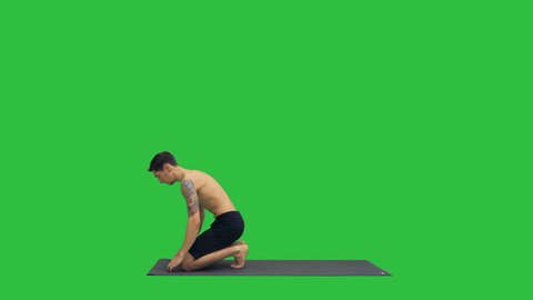 Young man doing yoga on a Green Screen, Chroma Key.