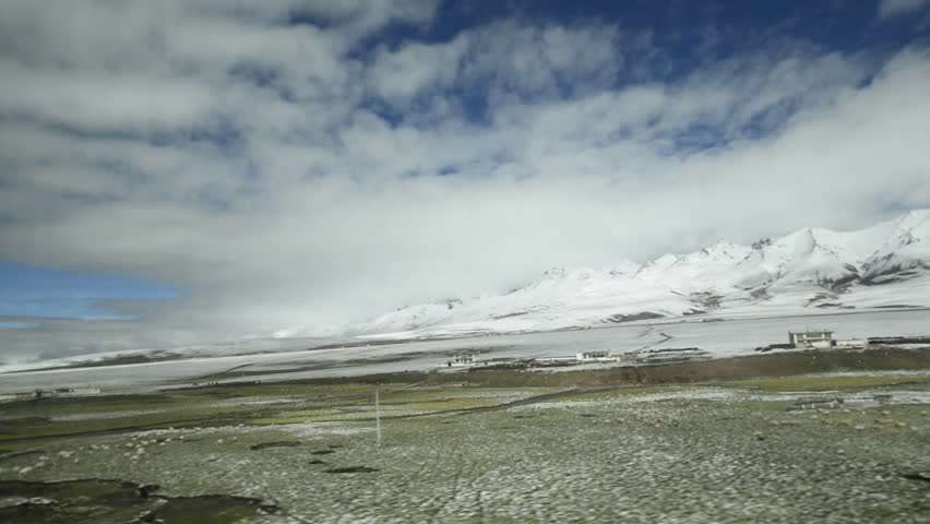 View through window of Qinghai–Tibet railway between Xining, Qinghai Province and Lhasa, Tibet Autonomous Region. The line leads up to 5.072 m (Tanggula Pass) and is the the world highest railway. Royalty-Free Stock Footage #1020253822