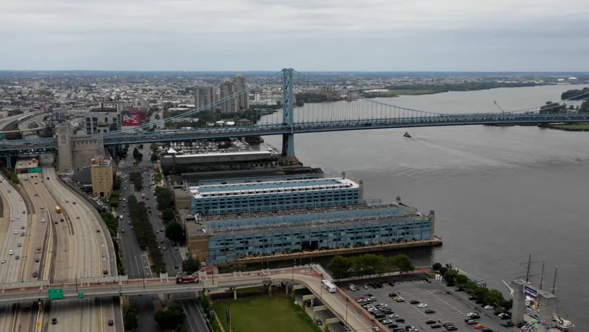 Aerial hyperlapse of the Benjamin Franklin Bridge and the Delaware River in Philadelphia.