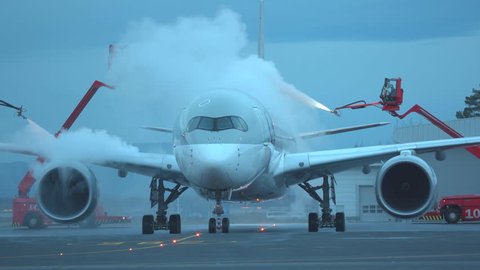 oslo airport norway - ca november 2018: airplane airbus a350 deicing crucial removal ice snow late evening