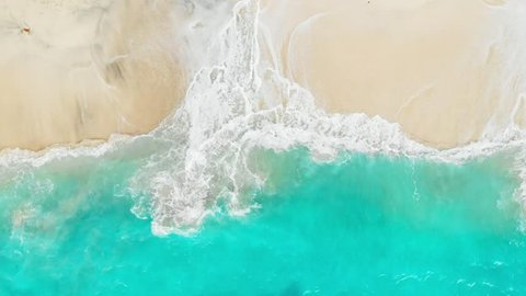 Tropical beach with turquoise ocean water and waves, aerial view. Top view of paradise island