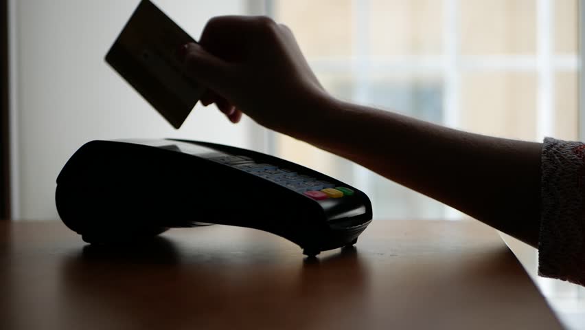 Close up of payment terminal on wooden surface and hands of girl with card Royalty-Free Stock Footage #1020268354