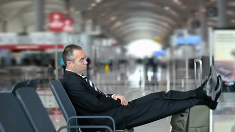 Passenger business man sleeping in the airport, waiting for flight