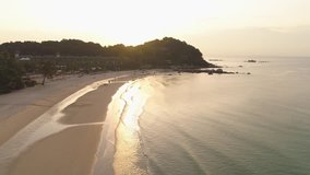 Sunset over beautiful sea coast with sandy beach, trees and isolated from big city hotel. Shot. Composition of nature, beautiful fiery sunset sky on the beach. - Powered by Shutterstock - Get 15% off with code: PIKWIZARD15
