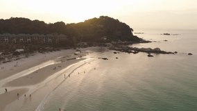 Sunset over beautiful sea coast with sandy beach, trees and isolated from big city hotel. Shot. Composition of nature, beautiful fiery sunset sky on the beach. - Powered by Shutterstock - Get 15% off with code: PIKWIZARD15