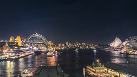 AUSTRALIA, SYDNEY - APRIL 29, 2018: Buzzing Sydney Harbour at night with the iconic Sydney Opera House and spectacular Sydney Harbour Bridge.