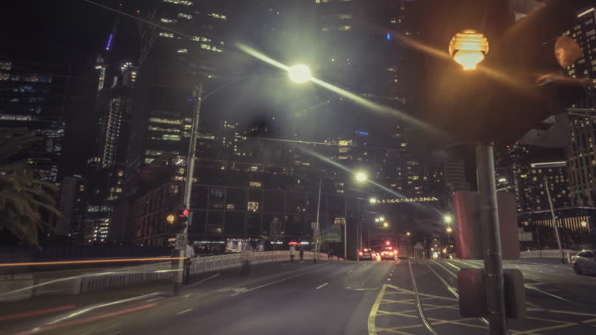 Timelapse of night road traffic on crossing with traffic lights in Melbourne, Australia