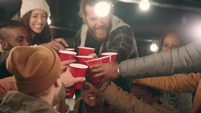 Red plastic cups cheers group of friends making toast drinking enjoying rooftop party celebration at night young multi ethnic people having fun socializing hanging out on weekend - Powered by Shutterstock - Get 15% off with code: PIKWIZARD15