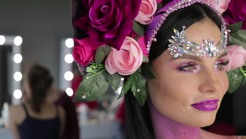 Woman with flowers and bright makeup