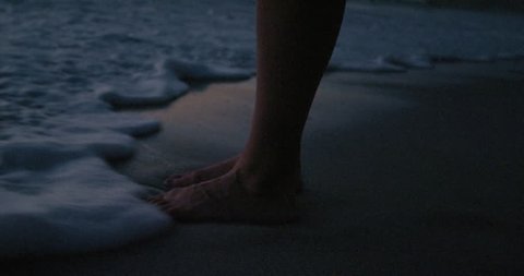 woman feet standing on beach waves splashing feet in seaside at sunrise slow motion beautiful water seaside footage in 4k Red Dragon