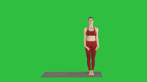 Woman practicing yoga, standing in Extended Side Angle exercise, Utthita parsvakonasana pose on a Green Screen, Chroma Key.