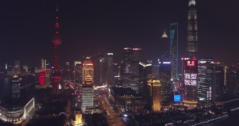 Shanghai China Circa-2017, side tracking aerial view of the Shanghai cityscape at night