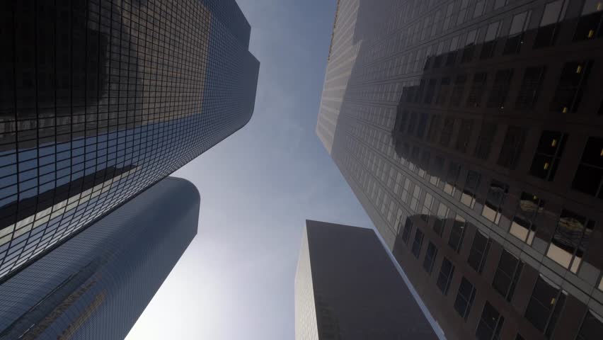 Dolly gliding looking up view of modern skyscrapers in Los Angeles city financial district 