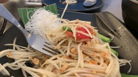 Spicy papaya salad with white noodle ,close up with fork,4k Video footage Clip