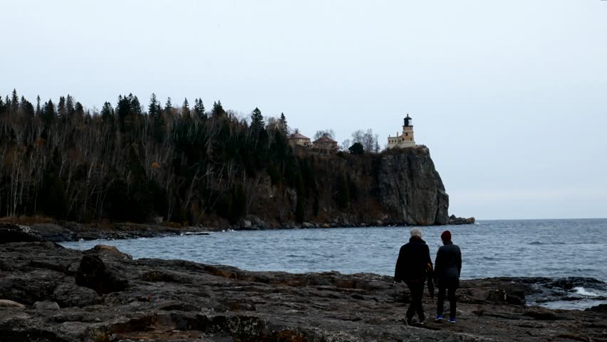 Senior women exploring shoreline at Split Rock Lighthouse on the north shore of Lake Superior near Duluth and Two Harbors, Minnesota