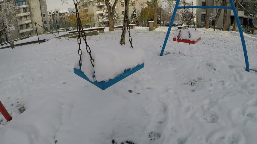a swing covered with a snow falls, 2.7K