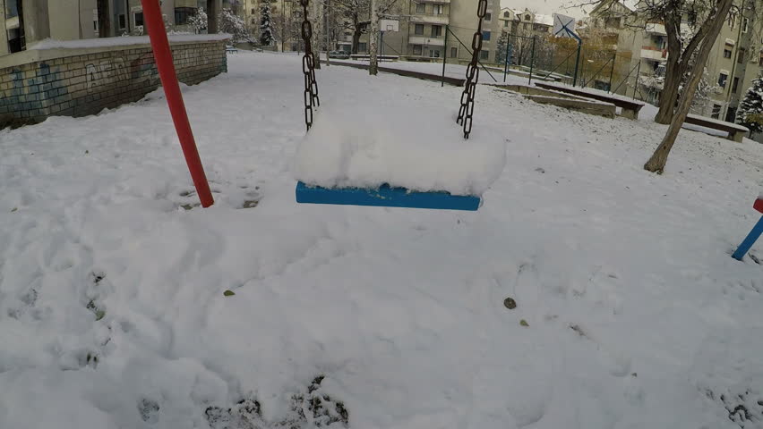 a swing covered with a snow falls, 2.7K