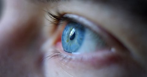 Close-up macro shot of young male human blue eye blinking in slow motion. Concept of moments of life, memory, eye care, optics., lens. Shot with RED 8K